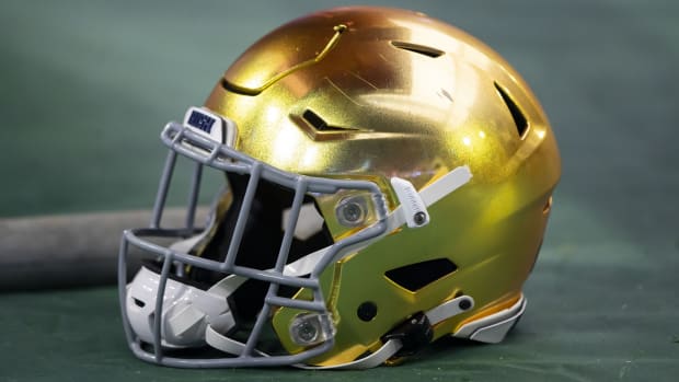 Jan 1, 2022; Glendale, Arizona, USA; Detailed view of a gold Notre Dame Fighting Irish helmet during the 2022 Fiesta Bowl at State Farm Stadium.