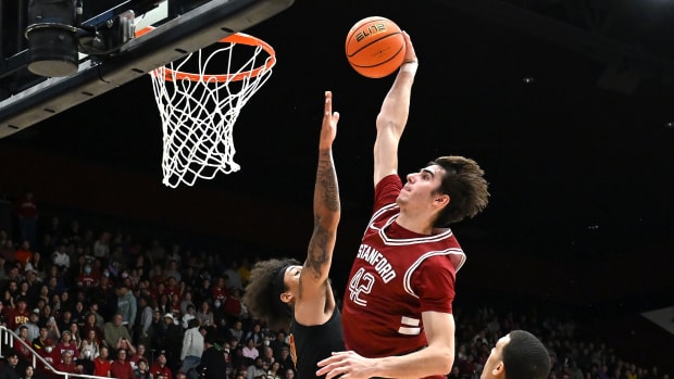 Feb 10, 2024; Stanford, California, USA; Stanford Cardinal forward Maxime Raynaud (42) dunks the ball against USC Trojans forward DJ Rodman (10) during the first half at Maples Pavilion. Mandatory Credit: Robert Edwards-USA TODAY Sports