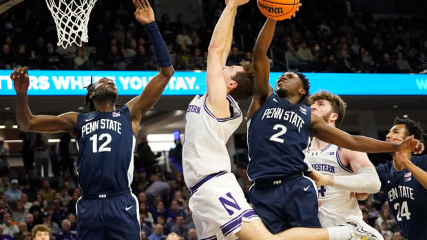 Penn State's D'Marco Dunn (2) blocks a shot against Northwestern's Ryan Langborg in a Big Ten men's basketball game.