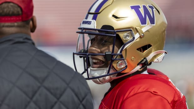 Feb 1, 2024; Mobile, AL, USA; National quarterback Michael Penix Jr of Washington (9) talks with National quarterbacks coach Israel Woolfork of the Arizona Cardinals during practice for the National team at Hancock Whitney Stadium.