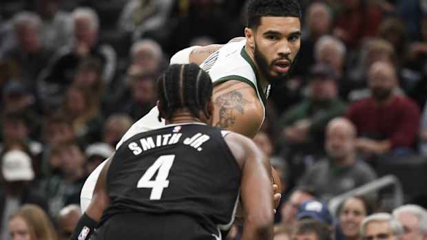 Boston Celtics forward Jayson Tatum (0) is guarded by Brooklyn Nets guard Dennis Smith Jr. (4)