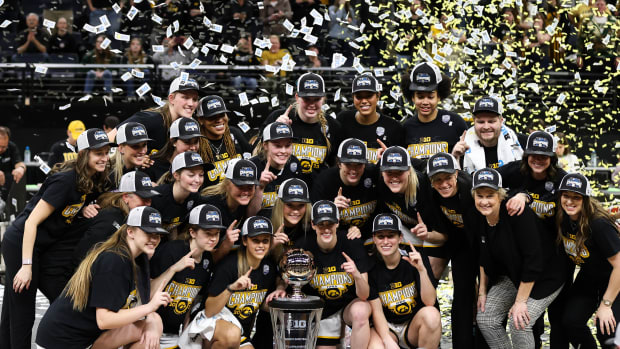 The Iowa Hawkeyes pose for a photo with the trophy after the game against the Ohio State Buckeyes at Target Center.