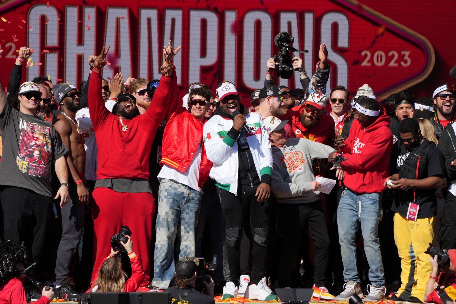 Feb 14, 2024; Kansas City, MO, USA; Kansas City Chiefs defensive tackle Chris Jones (95) addresses the crowd on stage with quarterback Patrick Mahomes (15) during the celebration of the Kansas City Chiefs winning Super Bowl LVIII. Mandatory Credit: Kirby Lee-USA TODAY Sports  