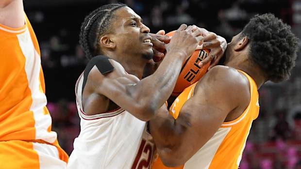 Razorbacks' Tramon Mark runs into Tennessee's Tobe Akwaka