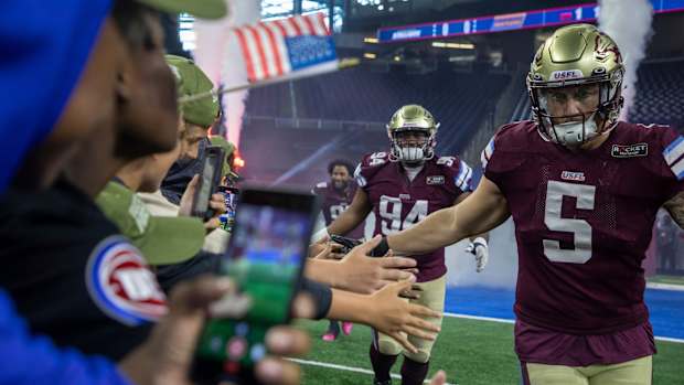Fans greet Michigan Panthers Jamal Milan (94), Frank Ginda (5) and their teammates as they walk into the field before the start of their game against the Birmingham Stallions at Ford Field in Detroit on Saturday, May 20, 2023.  