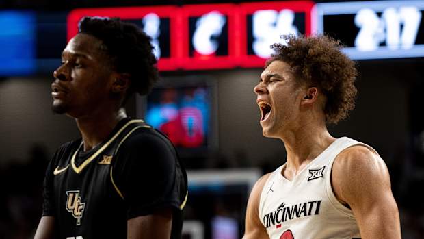 Cincinnati Bearcats guard Dan Skillings Jr. (0) reacts to hitting a 3-point basket over UCF Knights forward Marchelus Avery (13) to put Cincinnati Bearcats up by 5 points with under 3 minutes to play in the second half of the NCAA basketball game between Cincinnati Bearcats and UCF Knights at Fifth Third Arena in Cincinnati on Saturday, Jan. 27, 2024.