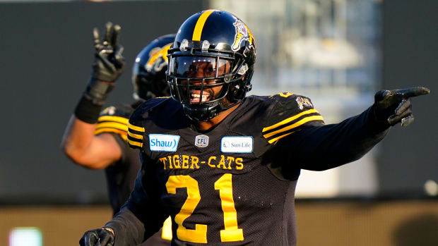 Nov 17, 2019; Hamilton, Ontario, CAN; Hamilton Tiger-Cats linebacker Simoni Lawrence (21) gestures to the Edmonton Eskimos during the CFL Eastern Conference Final football game at Tim Hortons Field. Mandatory Credit: John E. Sokolowski-USA TODAY Sports  