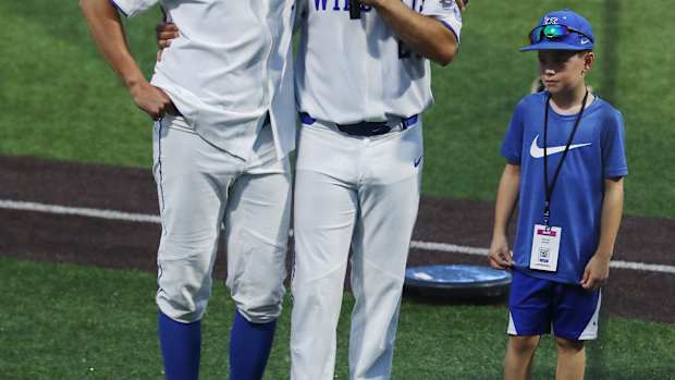 UK head baseball coach Nick Mingione, right, embraced pitcher Darren Williams (5) as he made remarks following their 4-2 victory against Indiana during the NCAA Regional final in Lexington Ky. on June 5, 2023. The win earned UK a spot in the upcoming Super Regional in Louisiana.