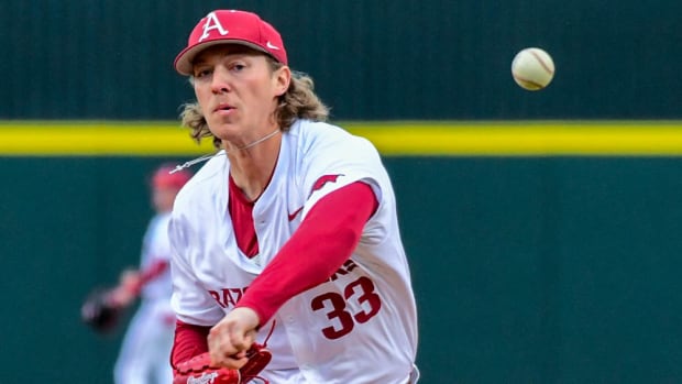 Razorbacks' Hagen Smith with a pitch in the first inning against James Madison