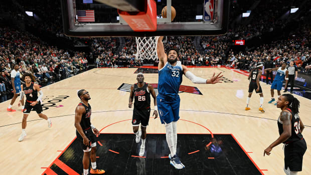 Feb 15, 2024; Portland, Oregon, USA; Minnesota Timberwolves center Karl-Anthony Towns (32) dunks the basketball during the second half against Portland Trail Blazers center Duop Reath (26) at Moda Center.