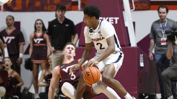 Virginia Cavaliers guard Reece Beekman (2) collides with Virginia Tech Hokies guard Sean Pedulla (3) in the second half at Cassell Coliseum.