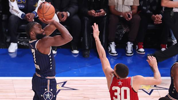 Jaylen Brown shoots over Stephen Curry
