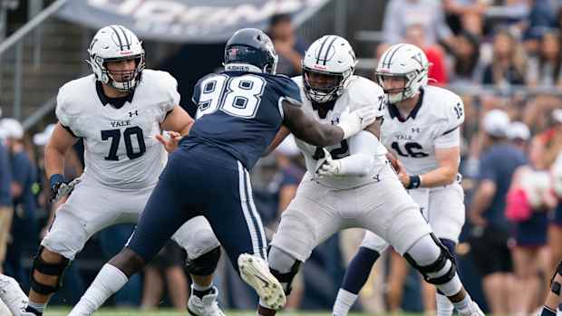 Yale Bulldogs offensive lineman Kiran Amegadjie (72) blocks Connecticut Huskies defensive lineman Lwal Uguak (98) during the first half at Rentschler Field at Pratt & Whitney Stadium.