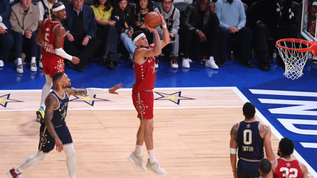Feb 18, 2024; Indianapolis, Indiana, USA; Western Conference guard Devin Booker (1) of the Phoenix Suns shoots the ball against Eastern Conference guard Damian Lillard (0) of the Milwaukee Bucks during the third quarter in the 73rd NBA All Star game at Gainbridge Fieldhouse. Mandatory Credit: Trevor Ruszkowski-USA TODAY Sports