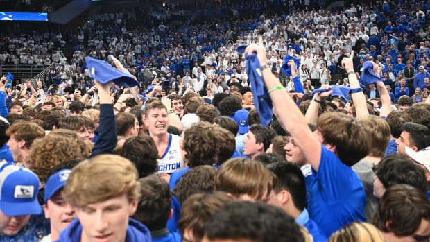 Creighton fans rush the court after beating UConn