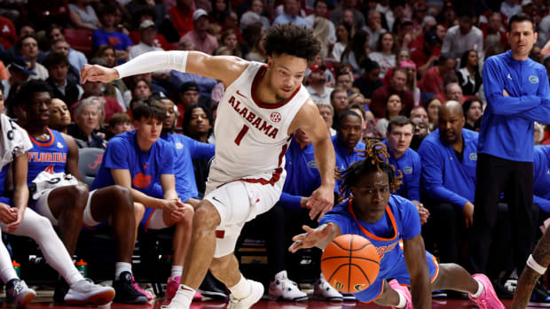 Feb 21, 2024; Tuscaloosa, Alabama, USA; Florida Gators guard Denzel Aberdeen (11) and Alabama Crimson Tide guard Mark Sears (1) reach for a loose ball during the first half at Coleman Coliseum. Mandatory Credit: Butch Dill-USA TODAY Sports