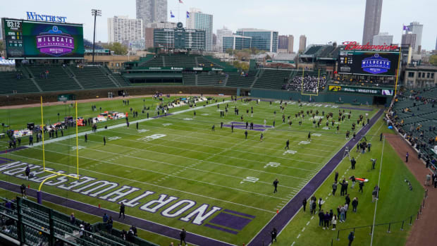 Players warm up before the game between the Northwestern Wildcats and the Iowa Hawkeyes at Wrigley Field.