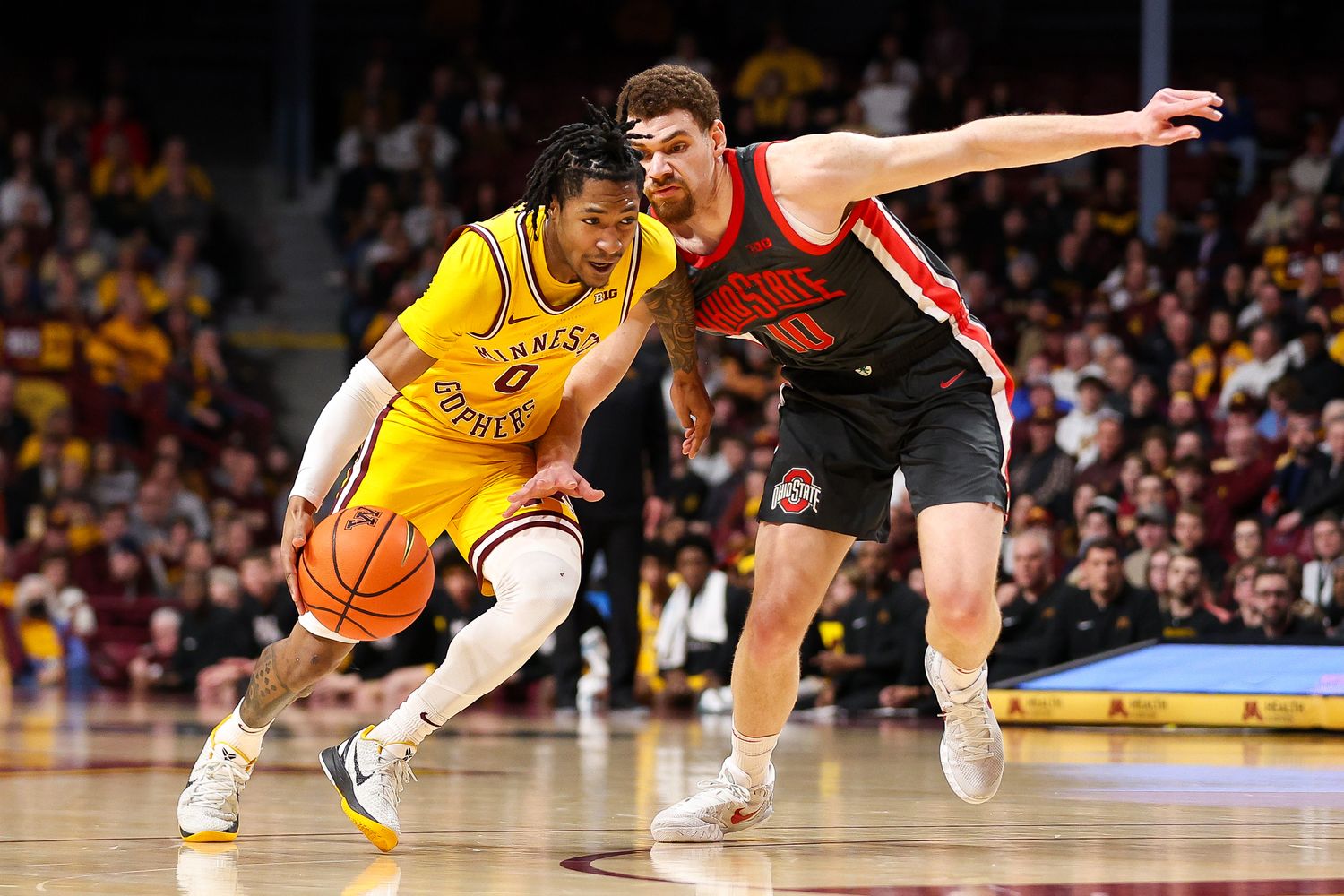 Minnesota guard Elijah Hawkins (0) works around Ohio State forward Jamison Battle (10) during the first half at Williams Arena in Minneapolis on Feb. 22, 2024.