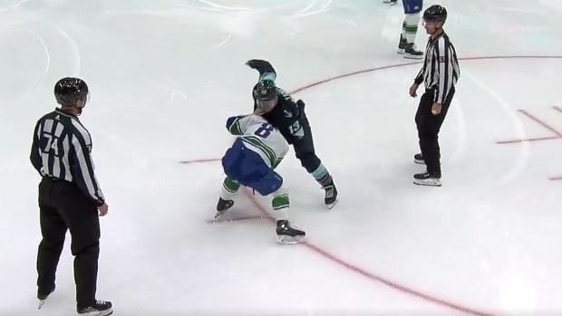Seattle Kraken forward Brandon Tanev fights Vancouver Canucks forward Conor Garland