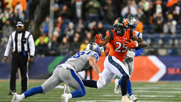 Feb 23, 2023; Seattle, WA, USA; Seattle Sea Dragons running back Morgan Ellison (25) and St. Louis Battlehawks defensive back Ben DeLuca (28) during the first half at Lumen Field. St. Louis defeated Seattle 20-18. Mandatory Credit: Steven Bisig-USA TODAY Sports  