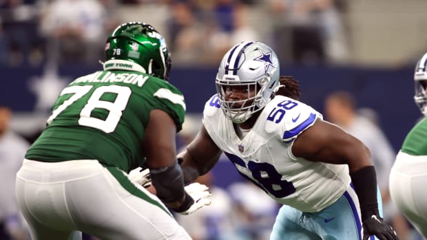 Sep 17, 2023; Arlington, Texas, USA; Dallas Cowboys defensive tackle Mazi Smith (58) rushes the passer while blocked by New York Jets guard Laken Tomlinson (78) in the third quarter at AT&T Stadium.