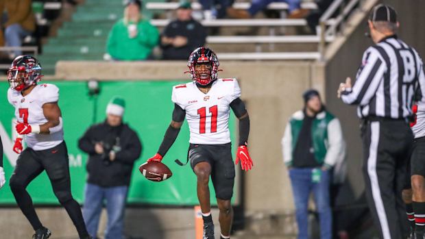 Nov 27, 2021; Huntington, West Virginia, USA; Western Kentucky Hilltoppers wide receiver Malachi Corley (11) catches a pass for a touchdown and celebrates with teammates during the third quarter against the Marshall Thundering Herd at Joan C. Edwards Stadium. Mandatory Credit: Ben Queen-USA TODAY Sports  