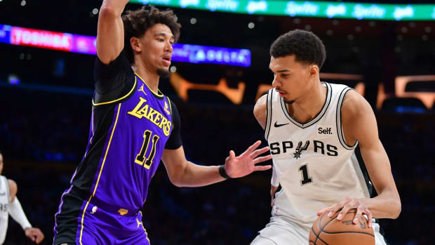 San Antonio Spurs star Victor Wembanyama dribbles the ball against Jaxson Hayes of the Los Angeles Lakers.