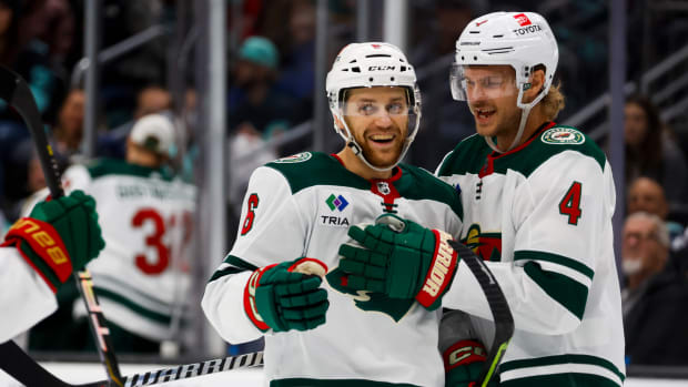 Minnesota Wild defenseman Dakota Mermis (6) celebrates with defenseman Jon Merrill (4) after scoring a goal against the Seattle Kraken during the second period at Climate Pledge Arena in Seattle on Feb. 24, 2024.