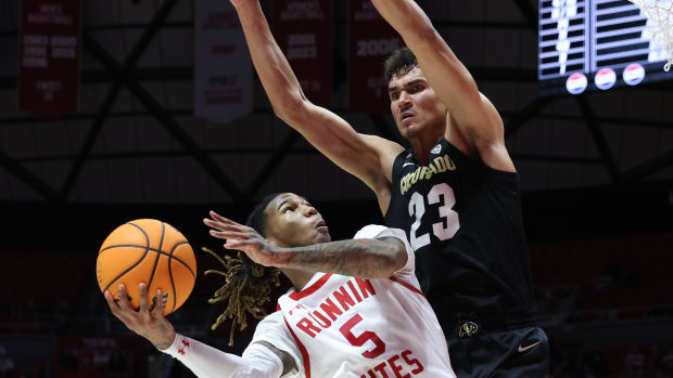 Utah Utes guard Deivon Smith (5) goes to the basket against Colorado Buffaloes forward Tristan da Silva (23) during the second half at Jon M. Huntsman Center