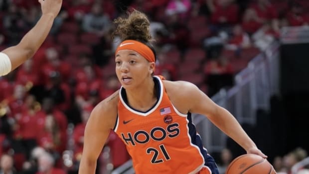 Kymora Johnson handles the ball during the Virginia women's basketball game against Louisville at KFC Yum! Center.
