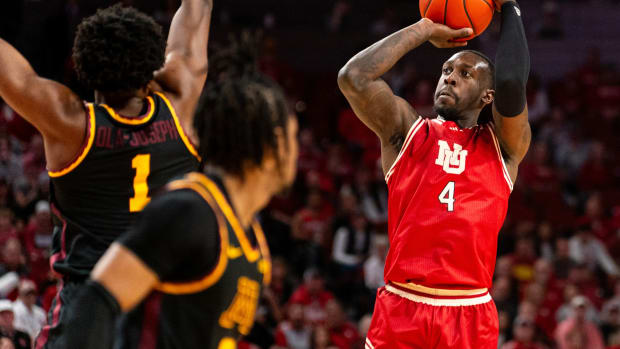 Feb 25, 2024; Lincoln, Nebraska, USA; Nebraska Cornhuskers forward Juwan Gary (4) shoots the ball against Minnesota Golden Gophers forward Joshua Ola-Joseph (1) and guard Elijah Hawkins (0) during the first half at Pinnacle Bank Arena.