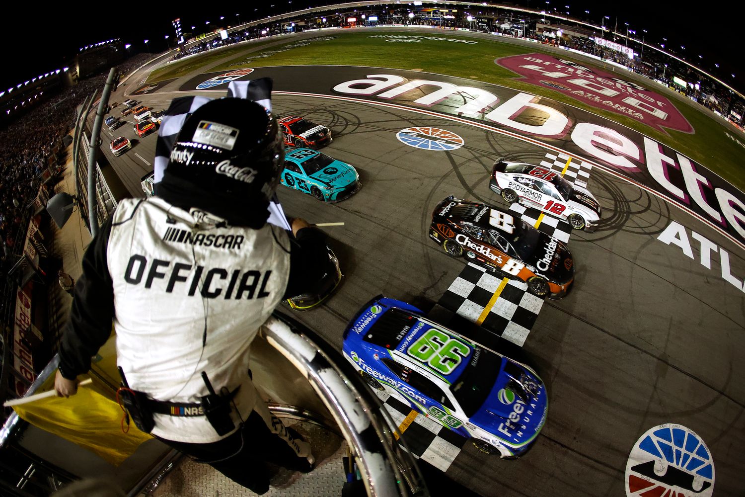 Daniel Suarez crosses the finish line ahead of Kyle Busch and Ryan Blaney to win the NASCAR Cup Series Ambetter Health 400 Sunday at Atlanta Motor Speedway. (Photo by Alex Slitz/Getty Images)