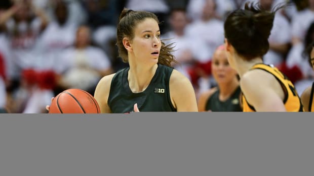 Feb 22, 2024; Bloomington, Indiana, USA; Indiana Hoosiers guard Yarden Garzon (12) looks for an open teammate during the second half against the Iowa Hawkeyes at Simon Skjodt Assembly Hall. Mandatory Credit: Marc Lebryk-USA TODAY Sports