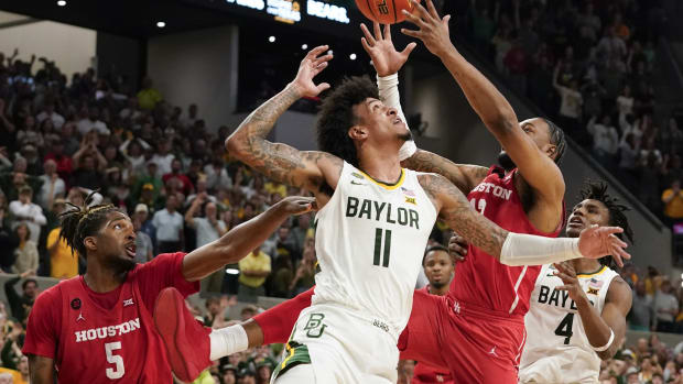 Houston Cougars forward J'Wan Roberts (13) grabs the rebound over Baylor Bears forward Jalen Bridges (11) during the second half at Paul and Alejandra Foster Pavilion. 