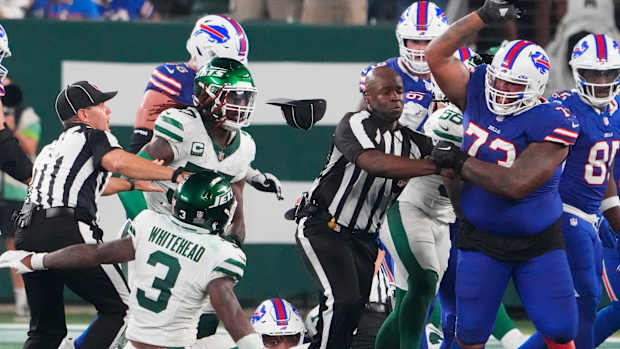 Sep 11, 2023; East Rutherford, New Jersey, USA; New York Jets safety Jordan Whitehead (3) gets pushed down by Buffalo Bills offensive tackle Dion Dawkins (73) in a scuffle following a Jets recovery of a Bills fumble in the second half at MetLife Stadium.