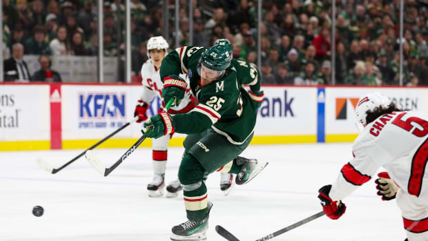 Feb 27, 2024; Saint Paul, Minnesota, USA; Minnesota Wild defenseman Jonas Brodin (25) shoots as Carolina Hurricanes defenseman Jalen Chatfield (5) defends during the second period at Xcel Energy Center.