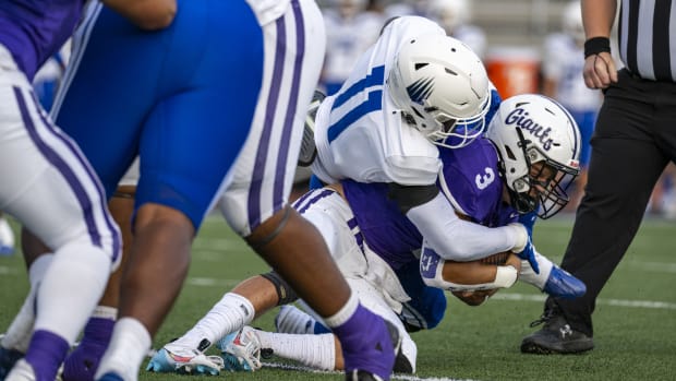 Ben Davis High School senior Thomas Gotkowski (3) is hit by IMG Academy High School junior Nathaniel Owusu-Boateng (11) as he runs the ball out of the backfield during the first half of an IHSAA varsity football game, Friday, Sept. 8, 2023, at Ben Davis High School.