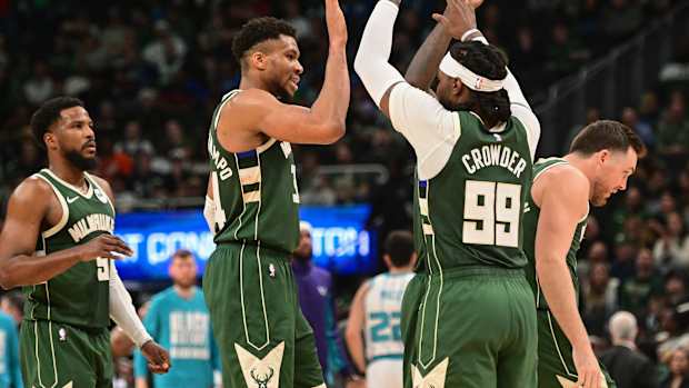 Milwaukee Bucks forward Giannis Antetokounmpo (34) celebrates with forward Jae Crowder (99) i