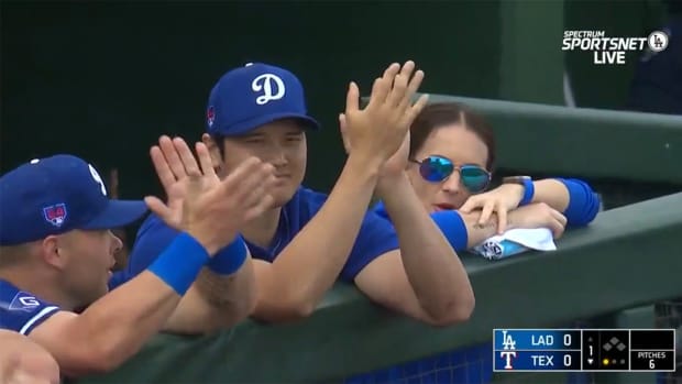 Shohei Ohtani watches from the dugout.