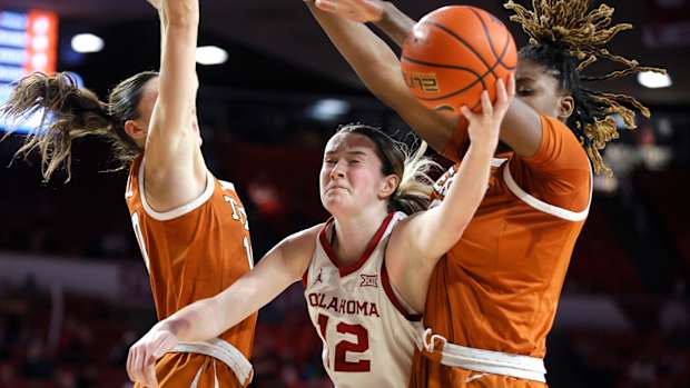 Oklahoma Sooners guard Payton Verhulst (12) puts up a shot between Texas Longhorns guard Shay Holle, left, and Texas Longhorns forward DeYona Gaston (5) during a women's college basketball game between the University of Oklahoma Sooners (OU) and the Texas Longhorns at Lloyd Noble Center in Norman, Okla., Wednesday, Feb. 28, 2024.