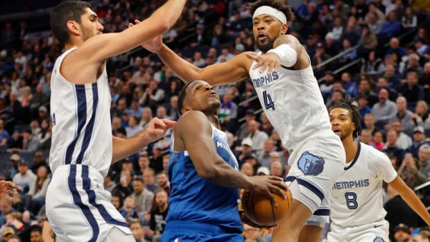 Minnesota Timberwolves guard Anthony Edwards (5) goes to the basket between Memphis Grizzlies forward Santi Aldama (7) and guard Jordan Goodwin (4) in the first quarter at Target Center in Minneapolis on Feb. 28, 2024.