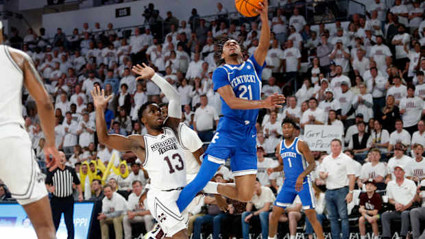 Feb 27, 2024; Starkville, Mississippi, USA; Kentucky Wildcats guard D.J. Wagner (21) shoots as Mississippi State Bulldogs guard Josh Hubbard (13) defends during the second half at Humphrey Coliseum. Mandatory Credit: Petre Thomas-USA TODAY Sports