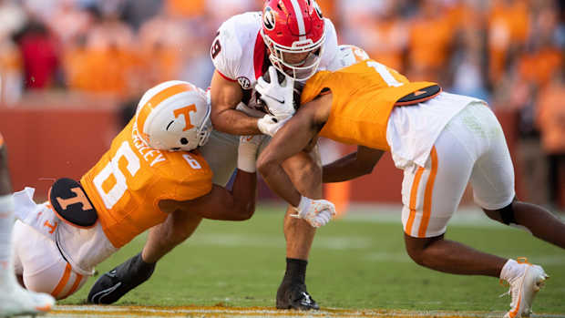 Georgia tight end Brock Bowers (19) is tackled by Tennessee linebacker Aaron Beasley (6) during a football game between Tennessee and Georgia at Neyland Stadium in Knoxville, Tenn., on Saturday, Nov. 18, 2023.