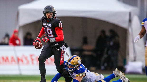 Nov 18, 2018; Calgary, Alberta, CAN; Winnipeg Blue Bombers defensive lineman Craig Roh (93) tackles Calgary Stampeders quarterback Bo Levi Mitchell (19) during the first half during the 2018 CFL Western Conference Final football game at McMahon Stadium. Mandatory Credit: Sergei Belski-USA TODAY Sports  