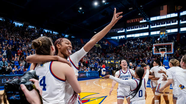 Kansas players celebrate a victory over the Kansas State Wildcats