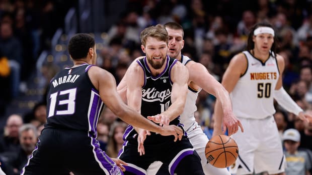 Feb 28, 2024; Denver, Colorado, USA; Denver Nuggets center Nikola Jokic (15) knocks the ball away from Sacramento Kings forward Domantas Sabonis (10) as forward Keegan Murray (13) defends in the second quarter at Ball Arena. Mandatory Credit: Isaiah J. Downing-USA TODAY Sports