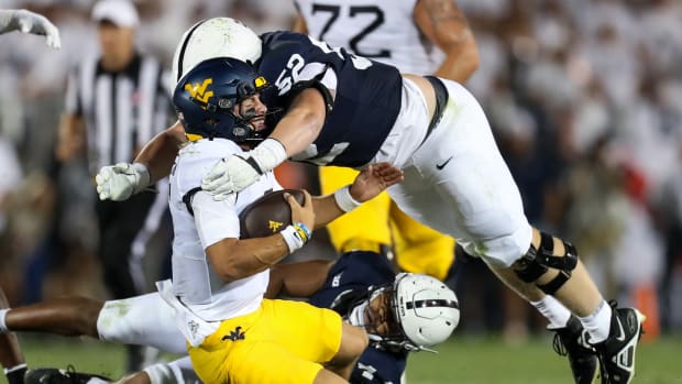 Penn State defensive lineman Jordan van den Berg makes a tackle against Iowa in a 2023 Big Ten game at Beaver Stadium.