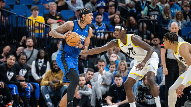 Feb 29, 2024; Orlando, Florida, USA; Orlando Magic forward Paolo Banchero (5) dribbles the ball against Utah Jazz forward Taylor Hendricks (0) in the fourth quarter at Kia Center.