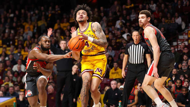 Minnesota guard Braeden Carrington (4) works towards the basket as Ohio State forward Jamison Battle (10) and guard Bruce Thornton (2) defend during the first half at Williams Arena in Minneapolis on Feb. 22, 2024.
