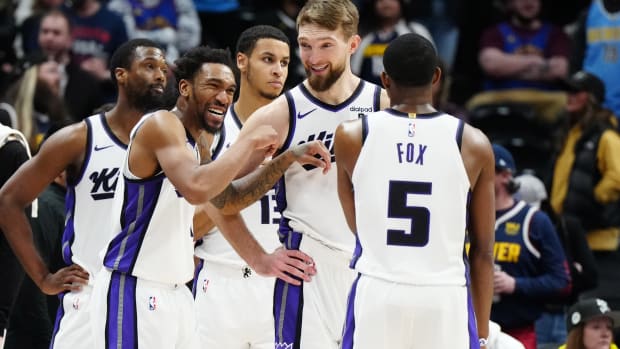 Feb 14, 2024; Denver, Colorado, USA; Sacramento Kings guard Malik Monk (0) and forward Domantas Sabonis (10) and guard De'Aaron Fox (5) react in the fourth quarter against the Denver Nuggets at Ball Arena. Mandatory Credit: Ron Chenoy-USA TODAY Sports
